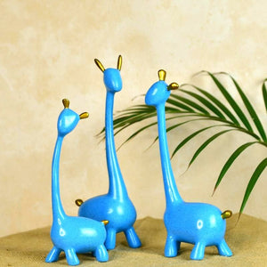 MAYII blue unique home decor giraffe set with gold accents on tabletop against beige background